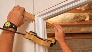 Installing trim and finishing touches to a remodeled basement in King of Prussia, PA and MD